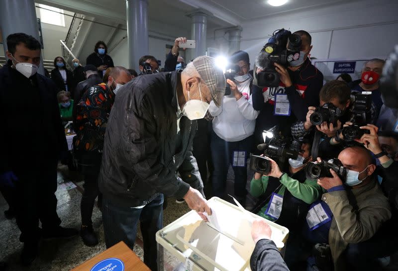 Actor and singer Kikabidze, who is at the top of the United National Movement party's electoral list, visits a polling station during a parliamentary election in Tbilisi