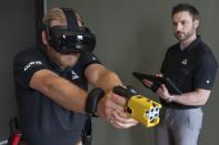 VR equipment and a version of the TASER 7 that utilizes VR technology for training, is demonstrated, Thursday, May 12, 2022, in Washington. Axon, the company that is best known for developing the Taser, is expanding virtual reality and immersive training in an effort to encourage police officers across the U.S. to more regularly train with less-than-lethal weapons. (AP Photo/Jacquelyn Martin)