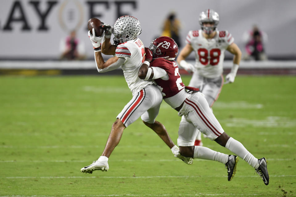 Ohio State WR Chris Olave, left, showed well in the national-title loss to Alabama. (Photo by Alika Jenner/Getty Images)