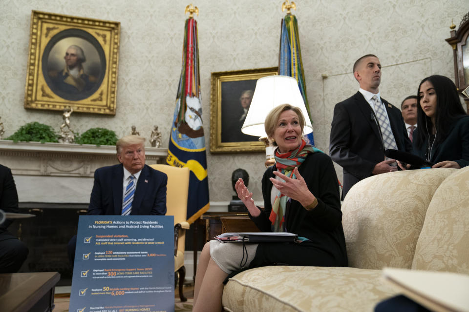 President Donald Trump listens as White House Coronavirus Response Coordinator Dr. Deborah Birx speaks about the coronavirus response during a meeting with Gov. Ron DeSantis, R-Fla., in the Oval Office of the White House, Tuesday, April 28, 2020, in Washington. (AP Photo/Evan Vucci)