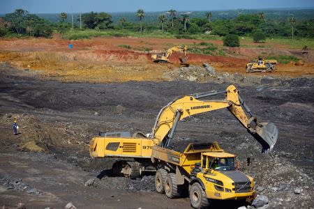 An excavator loads a truck at an area being prepared to be used by the lead and zinc mine Castellanos in Minas de Matahambre, Cuba, July 20, 2017. REUTERS/Alexandre Meneghini