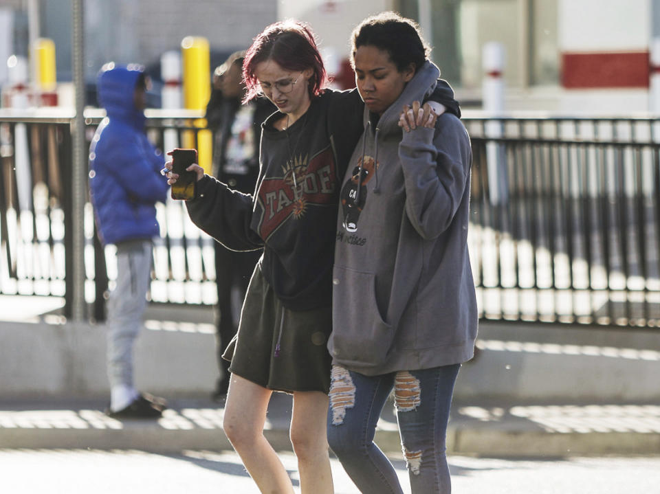 People are seen at the scene of a shooting on the University of Nevada, Las Vegas, campus on Wednesday, Dec. 6, 2023, in Las Vegas. (Madeline Carter/Las Vegas Review-Journal via AP)