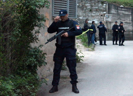 Members of special police take position in front of an attacked police station in Zvornik, April 27, 2015. REUTERS/Igor Golubovic