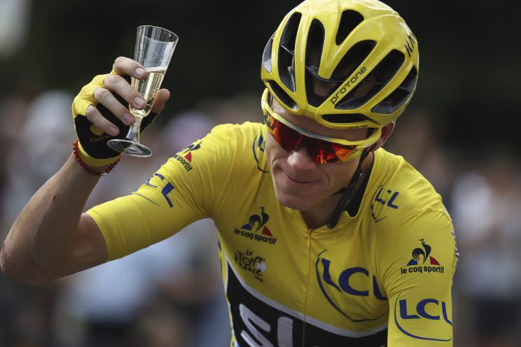 Britain's Chris Froome, wearing the overall leader's yellow jersey, celebrates with a glass of champagne during the twenty-first stage of the Tour de France cycling race over 113 kilometers (70.2 miles) with start in Chantilly and finish in Paris, France, Sunday, July 24, 2016. (Kenzo Tribouillard via AP Photo)