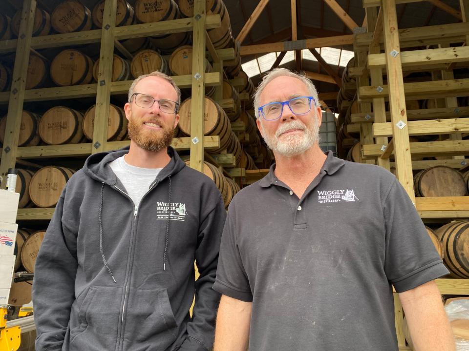 David Woods II (left) and his father David Woods plan to expand their Wiggly Bridge Distillery after 10 years in business on Route 1. Their last hurdle is the presence of nearby fungus neighbors fear will increase with the growth of the distillery.