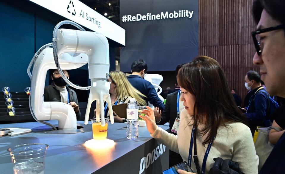 The Mix Master Moodie, an AI generated cocktail maker from Doosan Robotics, delivers a drink during a display at the Consumer Electronics Show (CES) on January 9, 2024 in Las Vegas, Nevada.