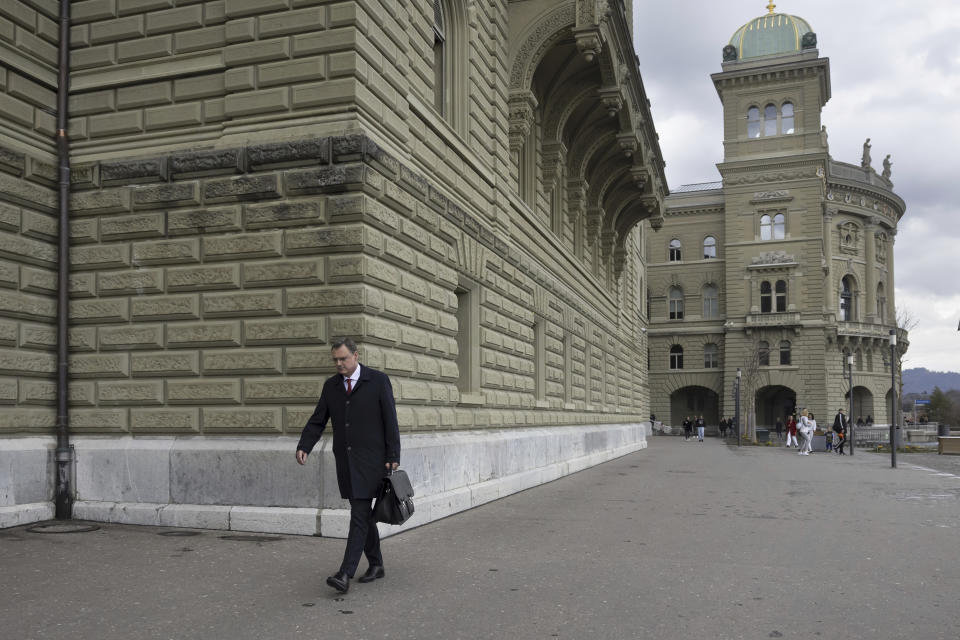 Thomas J. Jordan, Chairman of the Governing Board of the Swiss National Bank, walks in front of the government building on his way to the Bernerhof, headquarters of the Federal Department of Finance FDF, on Sunday, 19 March 2023 in Bern. The Federal Council, the Swiss National Bank and representatives of banks were meeting at the Bernerhof to negotiate the rescue of Credit Suisse or a possible merger with UBS. (Peter Klaunzer/Keystone via AP)