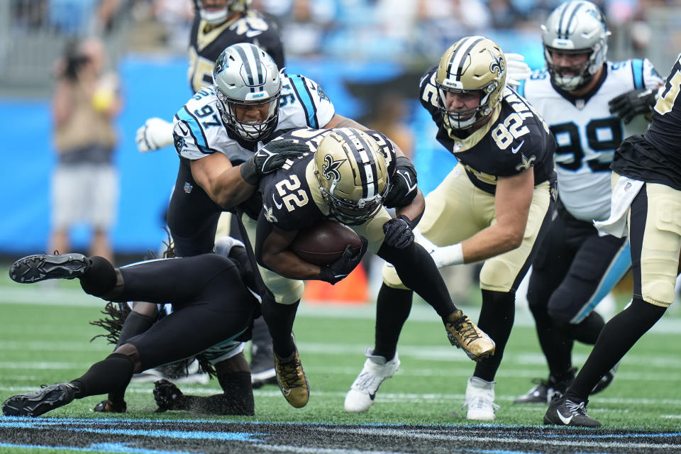 New Orleans Saints running back Mark Ingram II (22) runs the ball and is tackeld by Carolina Panthers defensive end Yetur Gross-Matos (97) during the first half of an NFL football game, Sunday, Sept. 25, 2022, in Charlotte, N.C. (AP Photo/Rusty Jones)