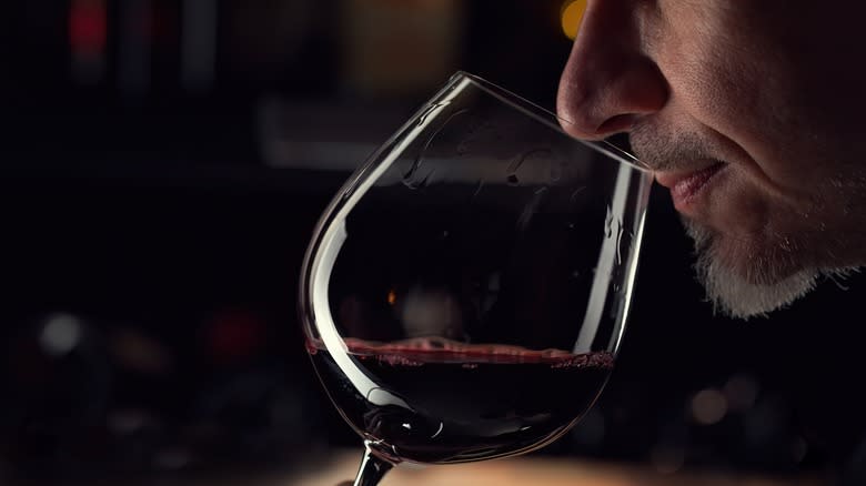 man sniffing red wine 