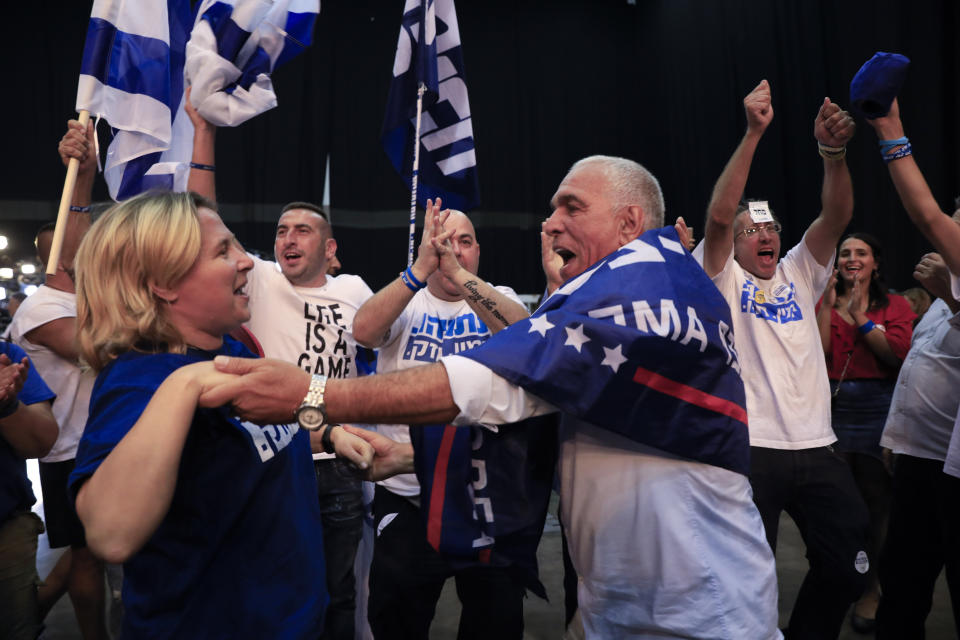 Israeli Prime Minister Benjamin Netanyahu supporters chant as the await results of the elections in Tel Aviv, Israel, Tuesday, Sept. 17, 2019. (AP Photo/Tsafrir Abayov)