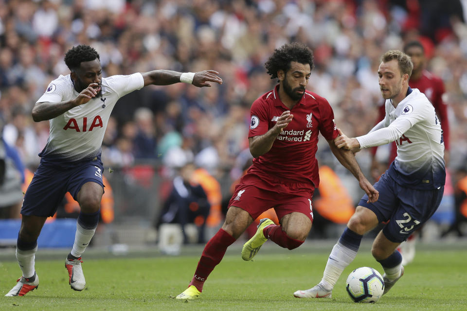 CAPTION CORRECTS SPELLING OF SURNAME Liverpool's Mohamed Salah, center, vies the ball past Tottenham's Christian Eriksen, right during the English Premier League soccer match between Tottenham Hotspur and Liverpool at Wembley Stadium in London, Saturday Sept. 15, 2018. (AP Photo/Tim Ireland)