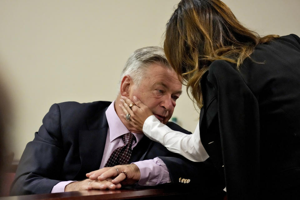 Actor Alec Baldwin interacts with his wife Hilaria Baldwin during his hearing in Santa Fe County District Court, Wednesday, July 10, 2024, in Santa Fe, N.M. Baldwin is facing a single charge of involuntary manslaughter in the death of a cinematographer. (AP Photo/Ross D. Franklin, Pool)