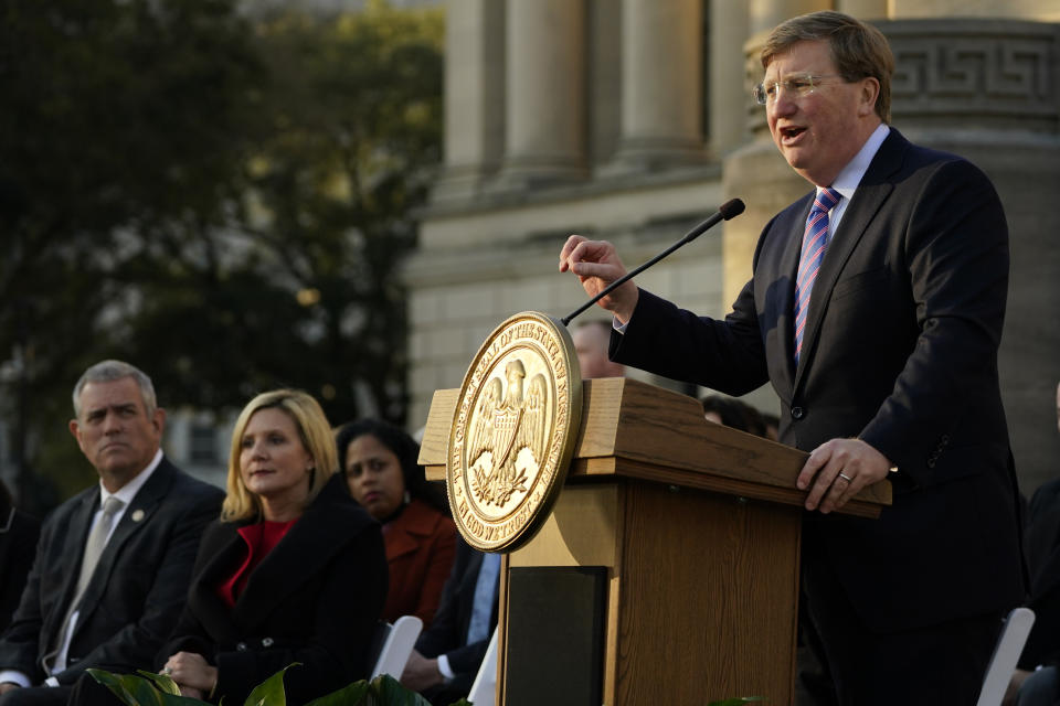 FILE - Mississippi Gov. Tate Reeves says during his State of the State speech on Jan. 25, 2022, at the state Capitol that he supports a proposal to phase out the state income tax. House Speaker Philip Gunn, right, and the governor’s wife, Elee Reeves, listen to the speech. (AP Photo/Rogelio V. Solis, File)