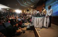 Malaysia's Minister of Transport Hishamuddin Hussein, center, Azharuddin Abdul Rahman, director general of the Malaysian Department of Civil Aviation, left and Malaysia Airlines Group CEO Ahmad Jauhari Yahya, right, listen to questions from the media during a press conference regarding missing Malaysia Airlines jetliner MH370, Friday, March 14, 2014 in Sepang, Malaysia. The international search for the missing Malaysian jetliner expanded westward Friday toward the Indian Ocean amid signs the aircraft may have flown on for hours after its last contact with air-traffic control nearly a week ago. (AP Photo/Wong Maye-E)