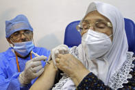 FILE - In this Jan. 30, 2021, file photo, woman receives the Sputnik-V COVID-19 vaccine at a vaccination center in Blida, south of Algiers, Algeria. Russia’s boast in August that it was the first country to authorize a coronavirus vaccine led to skepticism because of its insufficient testing on only a few dozen people. Now, with demand growing for the Sputnik V, experts are raising questions again, this time over whether Moscow can keep up with all the orders from countries that want it. (AP Photo/Fateh Guidoum, File)