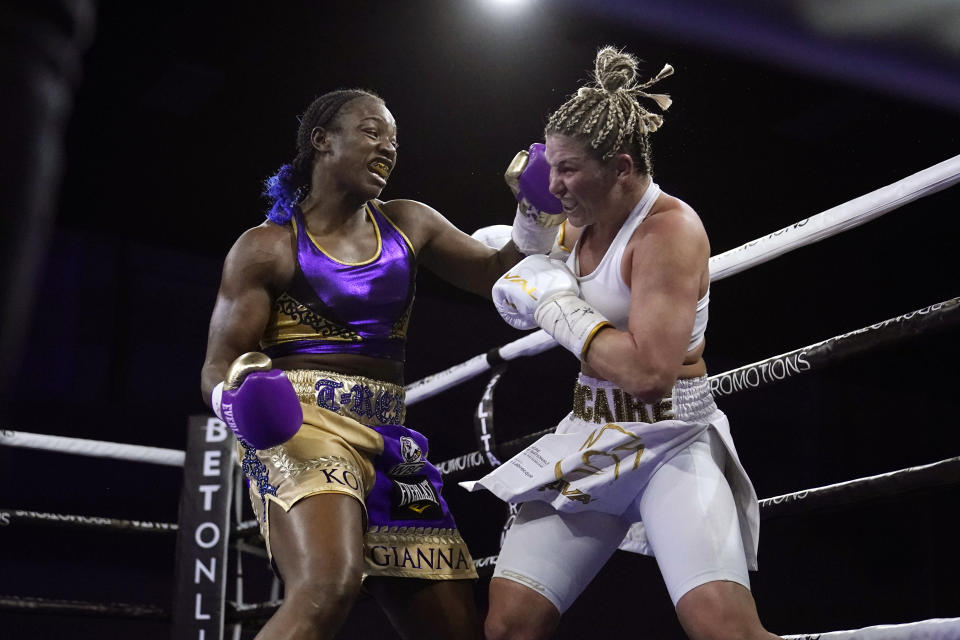 FILE - Claressa Shields, left, hits Marie-Eve Dicaire with a left during the fifth round of a boxing bout for the women's super welterweight title in Flint, Mich., in this Friday, March 5, 2021, file photo. The Professional Fighters League, the only MMA organization with a season format, returns after a year away for a card in Atlantic City. Kayla Harrison and Claressa Shields are among the stars expected to have breakout seasons this year and former UFC champion Anthony Pettis makes his PFL debut on Friday night, April 23, 2021. (AP Photo/Carlos Osorio, File)