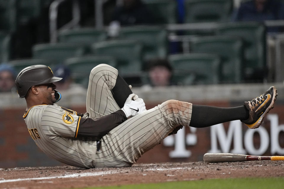 San Diego Padres shortstop Xander Bogaerts (2) reacts after fouling a ball off his leg in the ninth inning of a baseball game against the Atlanta Braves Saturday, April 8, 2023, in Atlanta. (AP Photo/John Bazemore)