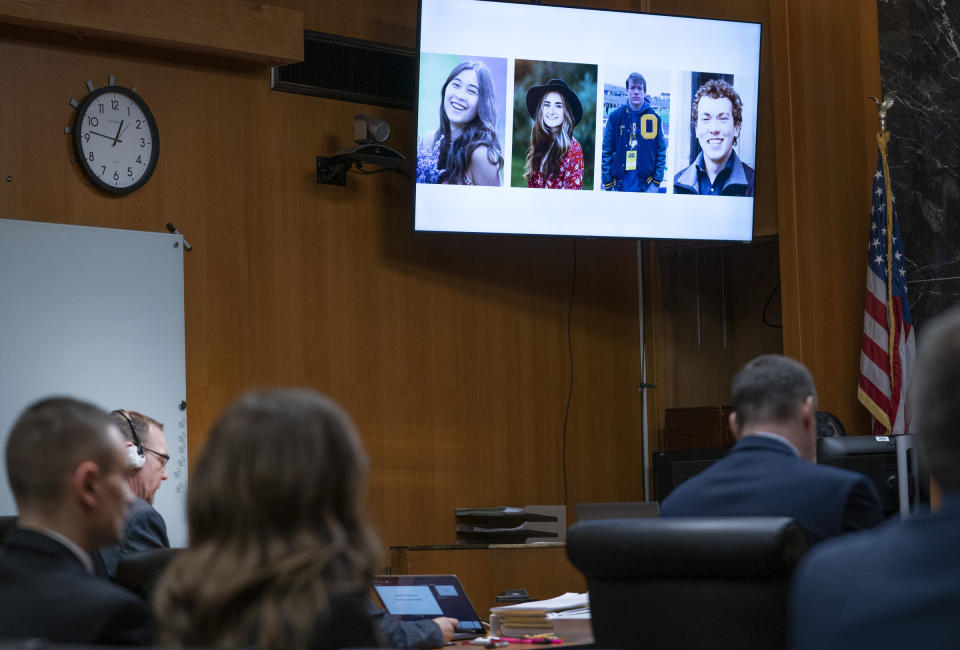 Photos of the four students killed in the Oxford High School shooting appear on a screen as closing arguments begin in the trial of James Crumbley who sits second from left in the Oakland County Courtroom of Cheryl Matthews on Wednesday, March, 13, 2024 in Pontiac, Mich. Crumbley is charged with involuntary manslaughter, accused of failing to secure a gun at home and ignoring his son's mental health. Ethan Crumbley killed four students at Oxford High School in 2021. (Mandi Wright/Detroit Free Press via AP, Pool)