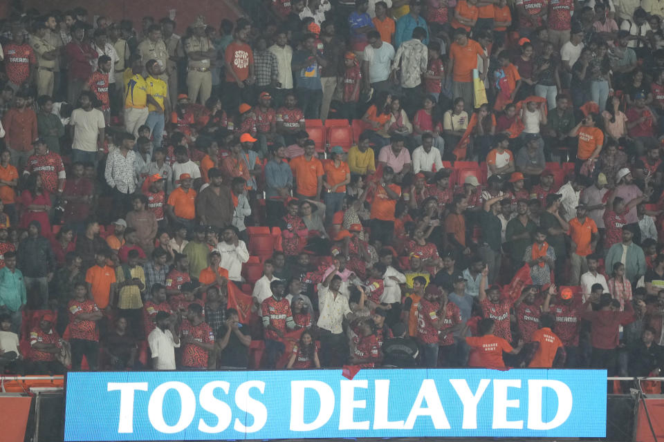 Fans wait as rain delays the play of an Indian Premier League cricket match between Sunrisers Hyderabad and Gujarat Titans in Hyderabad, India, Thursday, May 16, 2024. (AP Photo/Mahesh Kumar A.)