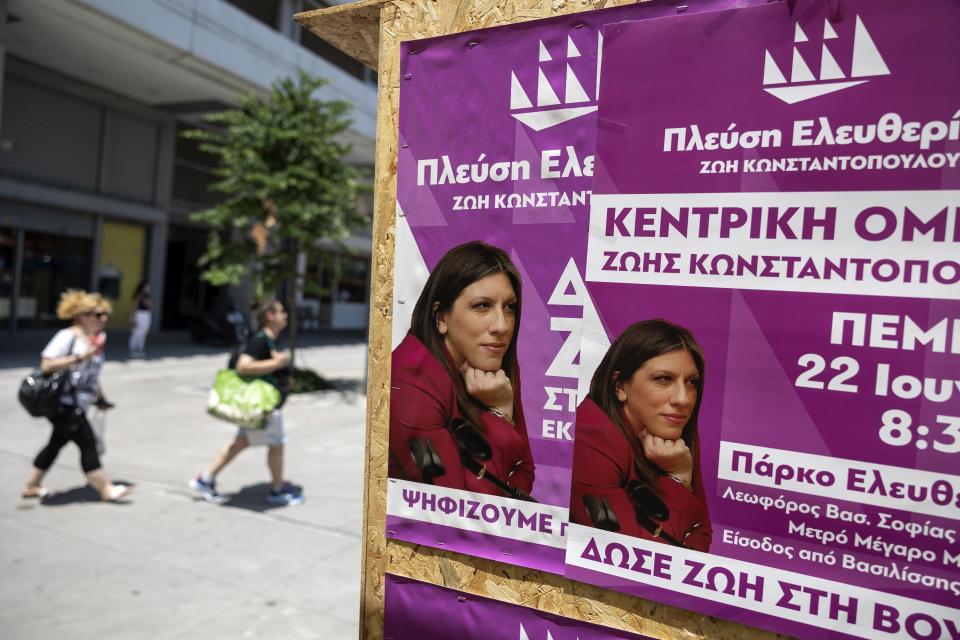 People walk past an election kiosk of Plefsi Eleftherias (Passage to Freedom) depicting the leader Zoe Konstantopoulou, in Athens, Greece, Thursday, June 22, 2023. Three far-right and two far-left, could conceivably cross the 3% parliamentary entry threshold in Sunday's elections, despite a swing back to mainstream politicians as the scars of Greece's 10-year financial crisis gradually heal. (AP Photo/Yorgos Karahalis)