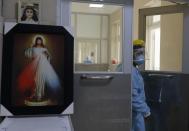 A nurse enters a COVID-19 unit at the Honorio Delgado Hospital in Arequipa, Peru, Friday, June 25, 2021. Due to increased cases of COVID-19 and the Delta variant of the disease, the city is under a strict lockdown for 15 days beginning June 21. (AP Photo/Guadalupe Pardo)