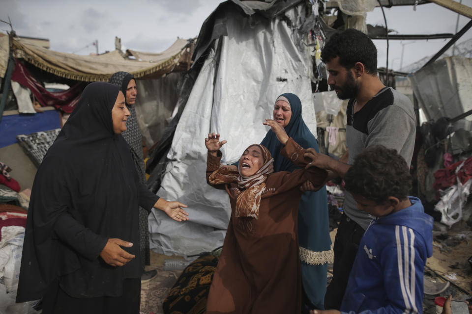 Displaced Palestinians inspect their tents destroyed by Israel's bombardment, adjunct to an UNRWA facility west of Rafah city, Gaza Strip, Tuesday, May 28, 2024. (AP Photo/Jehad Alshrafi)