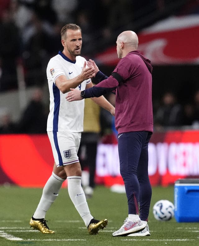 Lee Carsley, right, congratulates Harry Kane as he is substituted against Finland