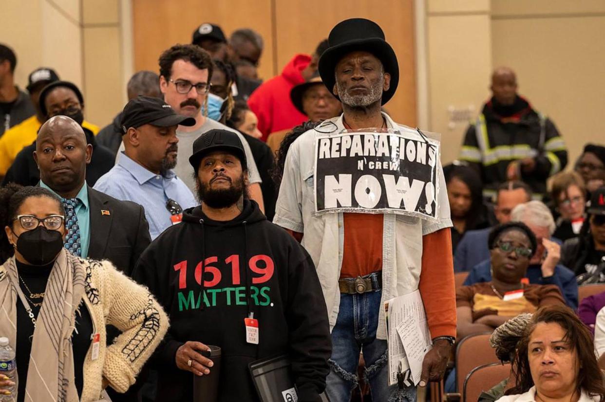 PHOTO: Morris Griffin, wearing a sign that says 'reparations now,' waits in a line to speak during public comment in 2023 at a meeting of the California Reparations Task Force, at the California Environmental Protection Agency in Sacramento, California. (Lezlie Sterling/The Sacramento Bee via TSN via Newscom, FILE)