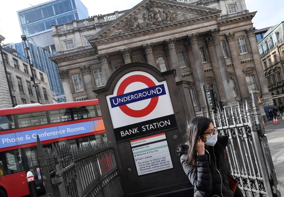 A woman wears a face mask in London: REUTERS