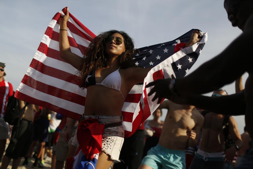 An U.S. soccer fan dances at the end of the 2014 World Cup soccer match between U.S. and Germany at Copacabana beach in Rio de Janeiro, June 26, 2014. REUTERS/Pilar Olivares (BRAZIL - Tags: SOCCER SPORT WORLD CUP)