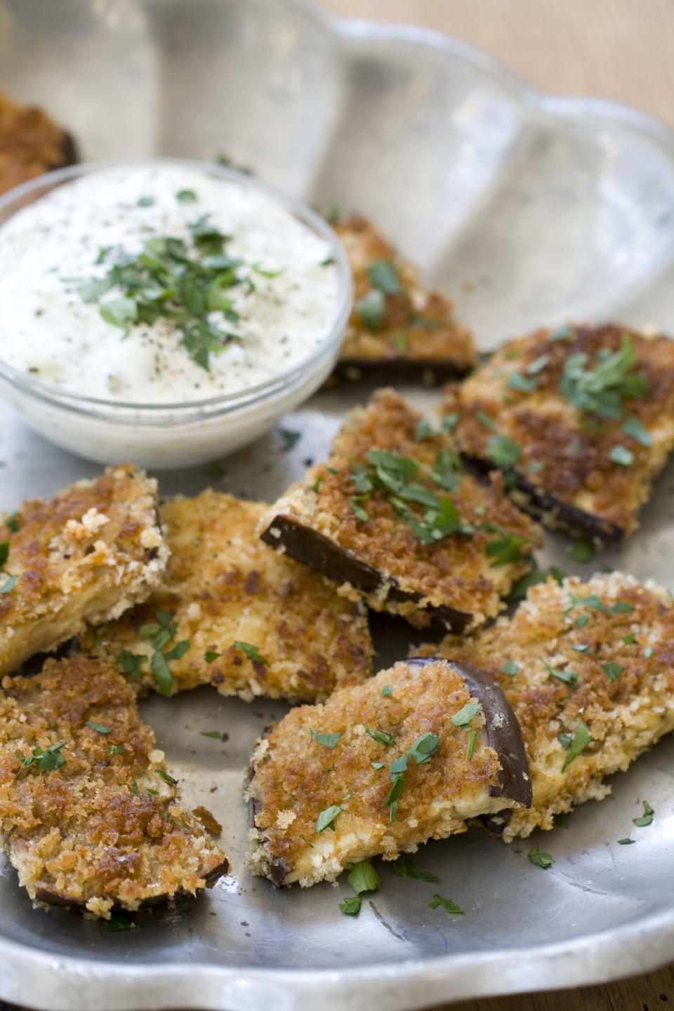 This Oct. 14, 2013 photo shows fried spiced eggplant with cucumber garlic sauce in Concord, N.H. One can make fried foods a little more healthy by changing what one fries. In this case, eggplant. (AP Photo/Matthew Mead)