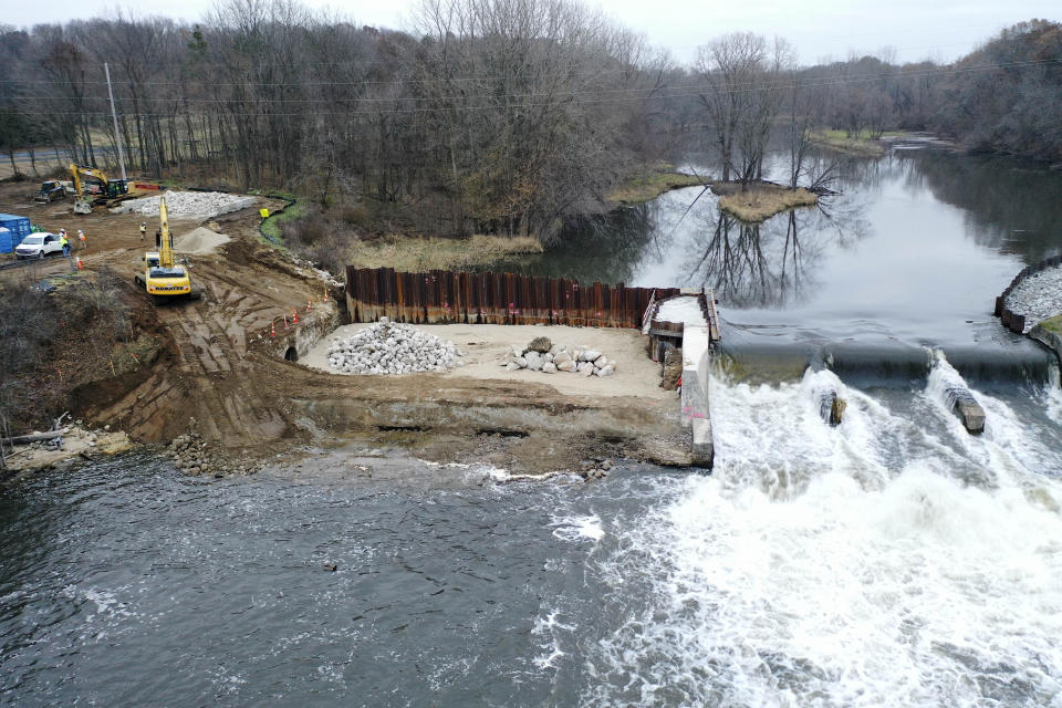 In this Thursday, Dec. 5, 2019 photo provided by the Environmental Protection Agency shows an aerial view of the dam stabilization project at the Trowbridge Dam on the Kalamazoo River near Allegan, Mich., in southwestern Michigan. The aging dam will be taken down under an agreement reached between federal officials and NCR Corp., one of the companies whose paper mills polluted the river with toxic PCBs in the last century. (Paul Ruesch/Environmental Protection Agency via AP)