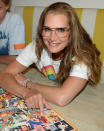 <p>Brooke Shields works on a puzzle that features her '80s Calvin Klein ad while at home in New York City with her daughters on Monday.</p>