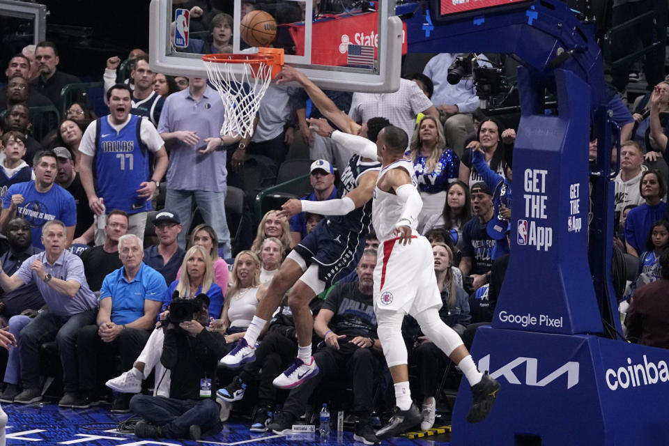 Dallas Mavericks' Josh Green is defended by Los Angeles Clippers' Russell Westbrook, right, on a shot attempt during the first half of Game 2 of an NBA basketball first-round playoff series Friday, April 26, 2024, in Dallas. Westbrook was called for a flagrant foul on the play. (AP Photo/Tony Gutierrez)