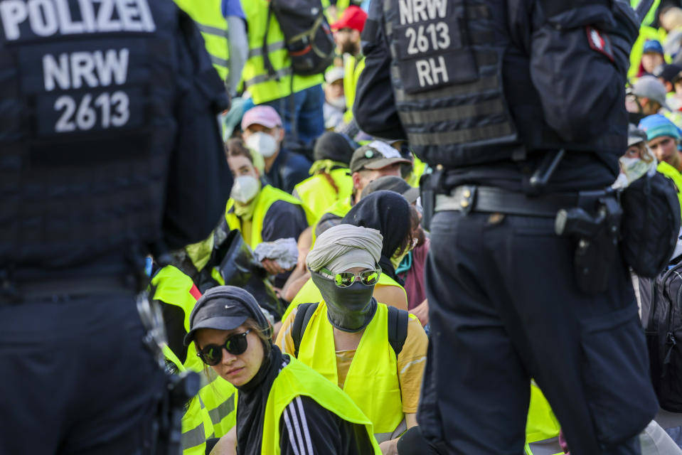 Demonstrators sit on a street surrounded by police officers in Essen, Germany Saturday, June 29, 2024. A few hours before the start of the AfD national party conference, demonstrators had their first clash with the police on Saturday morning.(dpa via AP)