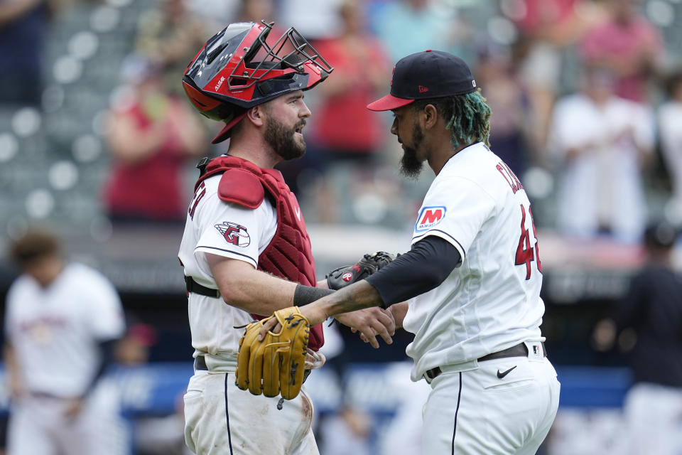 Cleveland Guardians catcher Cam Gallagher, left, and relief pitcher Emmanuel Clase, right, celebrate after the Guardians defeated the Minnesota Twins in a baseball game Wednesday, Sept. 6, 2023, in Cleveland. (AP Photo/Sue Ogrocki)