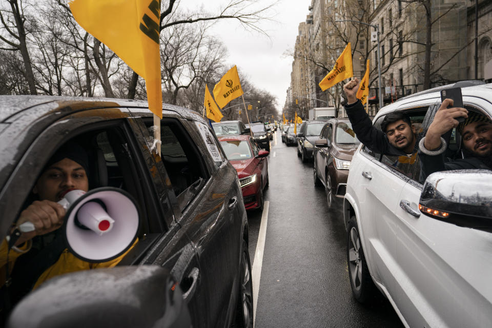 A convoy of protesters drive down Fifth Avenue past the Consulate General of India, Tuesday, Jan. 26, 2021, in the Manhattan borough of New York. Tens of thousands of protesting farmers have marched, rode horses and drove long lines of tractors into India's capital, breaking through police barricades to storm the historic Red Fort. The farmers have been demanding the withdrawal of new laws that they say will favor large corporate farms and devastate the earnings of smaller scale farmers. Republic Day marks the anniversary of the adoption of India’s constitution on Jan. 26, 1950. (AP Photo/John Minchillo)