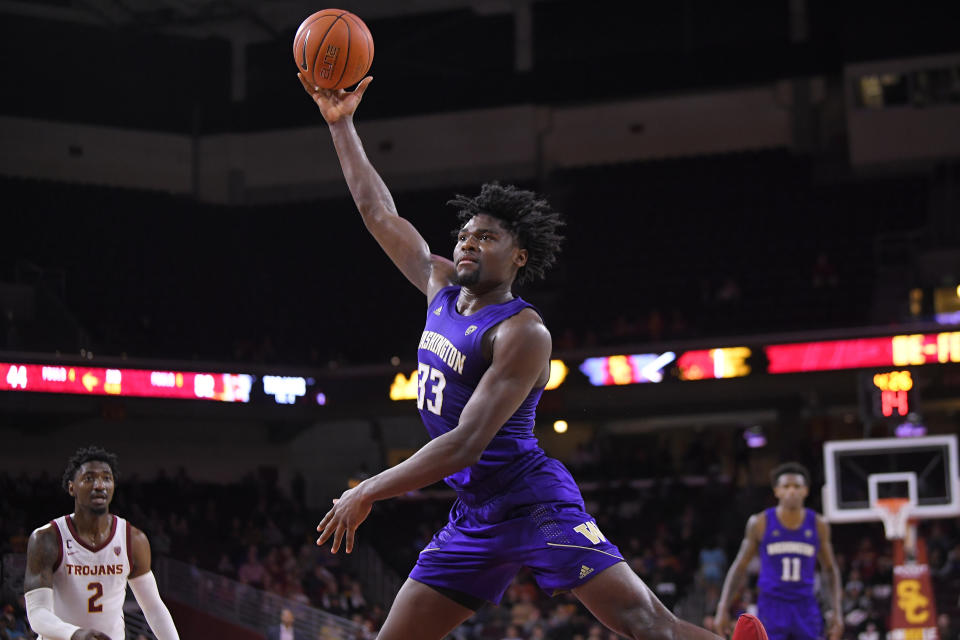 Washington forward Isaiah Stewart, center, shoots as Southern California guard Jonah Mathews, left, watches during the second half of an NCAA college basketball game Thursday, Feb. 13, 2020, in Los Angeles. (AP Photo/Mark J. Terrill)