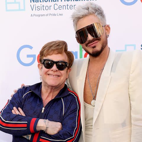 <p>Kevin Mazur/Getty</p> Elton John and Adam lambert