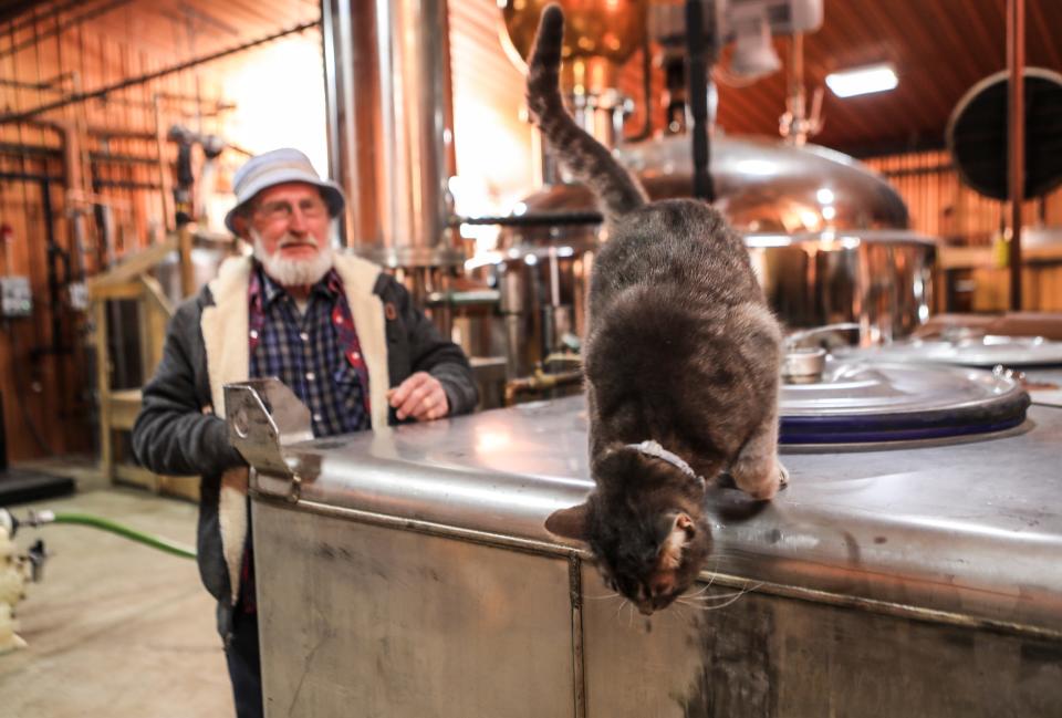 Earl "Pawpaw" Sizemore with his cat Thumper at the Neeley Family Distillery, a small bourbon and whiskey operation in Sparta, Ky.