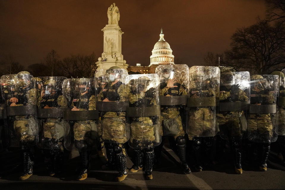 Image: District of Columbia National Guard stand outside the Capitol on Wednesday night after a day of rioting protesters. (John Minchillo / AP)