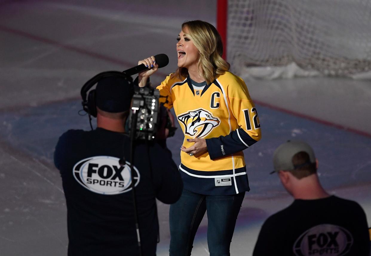 Carrie Underwood, wife of Nashville Predator Mike Fisher, sings the national anthem before the start of Game 3 in the first-round NHL playoff series at Bridgestone Arena on April 17, 2017.