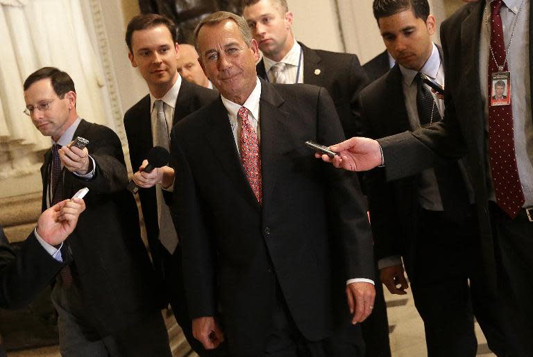House Speaker John Boehner (C) walks to the House chamber for a vote on a $1.1 trillion government funding bill on December 11, 2014 in Washington, DC