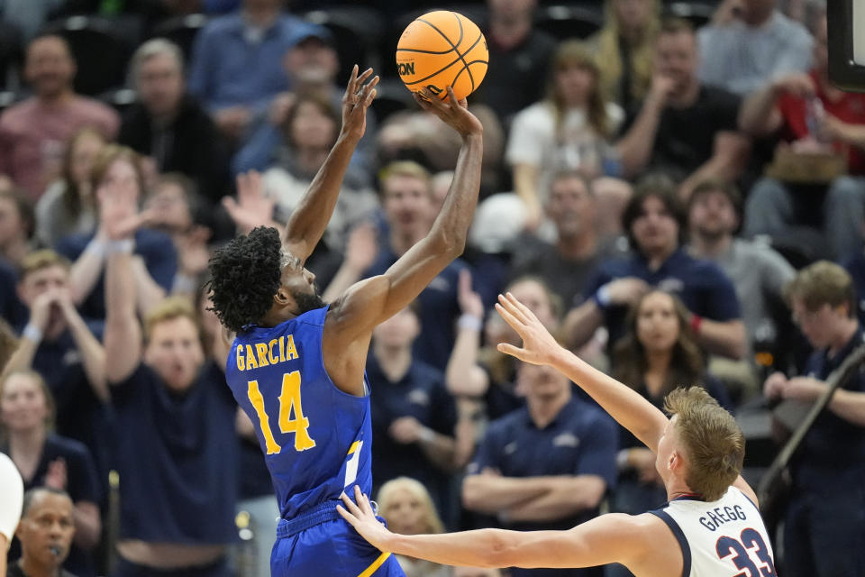 McNeese State guard Javohn Garcia (14) shoots as Gonzaga forward Ben Gregg (33) defends during the first half of a first-round college basketball game in the NCAA Tournament in Salt Lake City, Thursday, March 21, 2024. (AP Photo/Rick Bowmer)