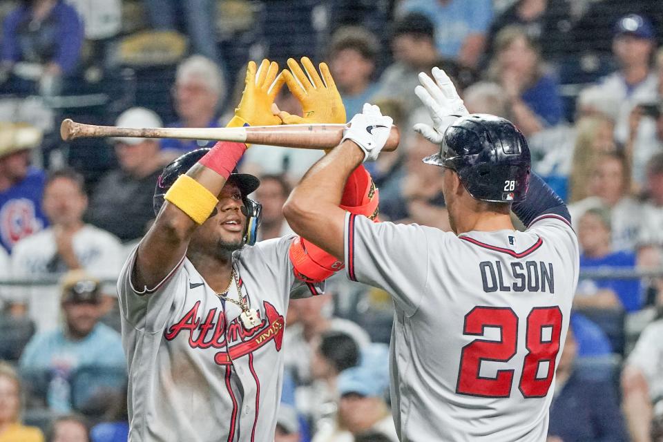 Atlanta Braves right fielder Ronald Acuna Jr., left, celebrates with first baseman Matt Olson after hitting a solo home run during an April14, 2023 game.