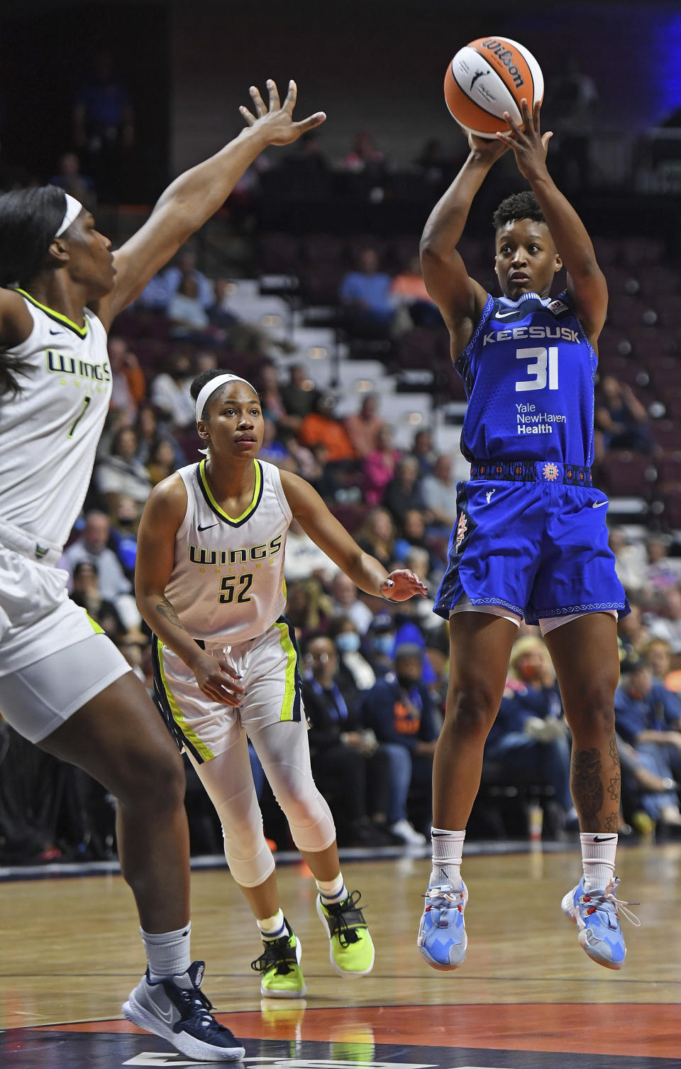 onnecticut Sun guard Yvonne Anderson (31) shoots over Dallas Wings center Teaira McCowan (7) during the first half of a WNBA basketball game Tuesday, May 24, 2022 at Mohegan Sun Arena in Uncasville, Conn. (Sean D. Elliot/The Day via AP)