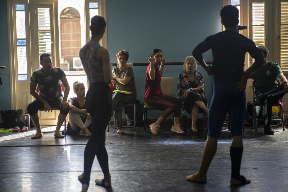 The director of national ballet of Cuba Viengsay Valdés, center, guides a practice with her dancers in Havana, Cuba, Thursday, Dec. 12, 2019. Valdes, the new head of Cuba's legendary National Ballet, says she hopes to renew the institution after the death of long-time director Alicia Alonso by introducing new choreography and appearances by dancers who have emigrated to other companies. (AP Photo/Ramon Espinosa)