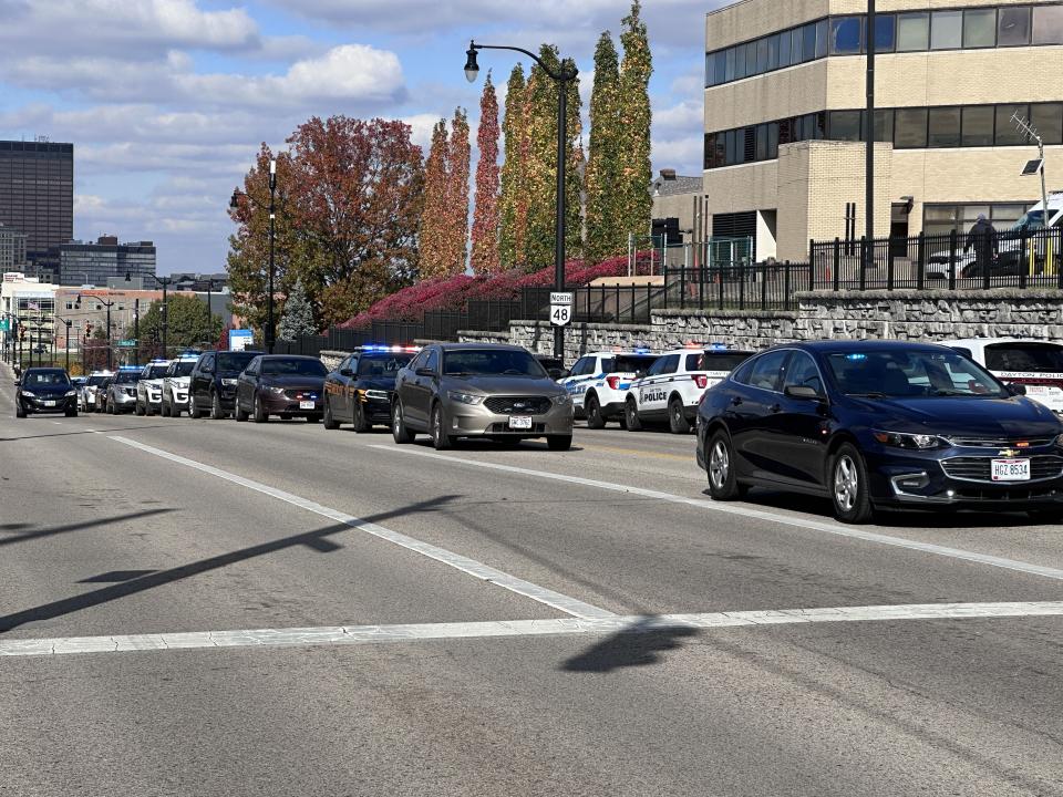 Dozens of officers and state troopers from across several cities in Montgomery and Greene counties gathered outside Miami Valley Hospital Tuesday as Officer Cody Cecil was released from Miami Valley Hospital five days after he was shot while serving a warrant in Clayton. (Scott Kessler/Staff)