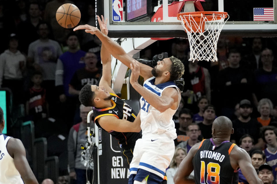 Minnesota Timberwolves center Rudy Gobert (27) blocks the shot of Phoenix Suns guard Devin Booker during the first half of an NBA basketball game, Tuesday, Nov. 1, 2022, in Phoenix. (AP Photo/Matt York)
