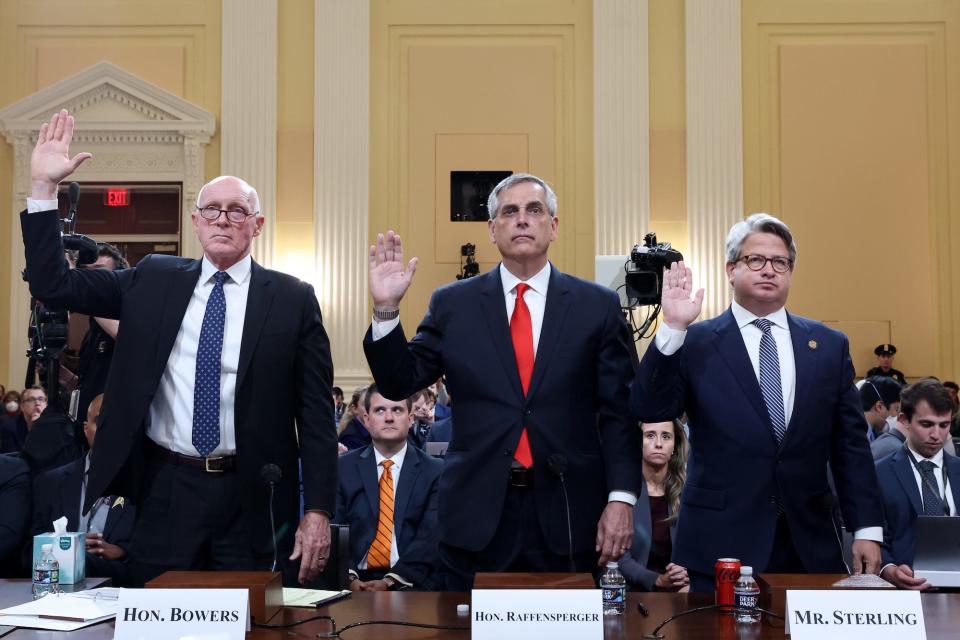 Arizona House Speaker Rusty Bowers (L), Georgia Secretary of State Brad Raffensperger (C), and Georgia Secretary of State Chief Operating Officer Gabriel Sterling (R), all stand with their right hands raised while being sworn in for the January 6 committee's fourth public hearing on Thursday, June 21 on Capitol Hill.